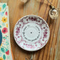 Coupelle ronde fleurs prunes chinée en porcelaine - décor Phrase mantra